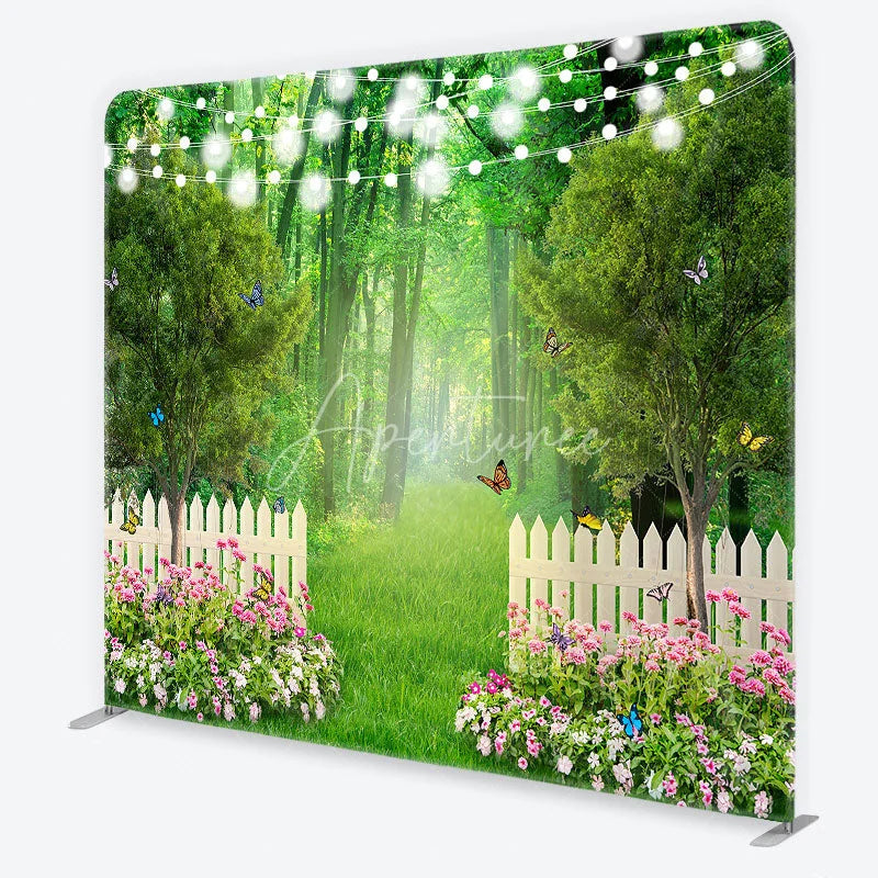 Aperturee - Aperturee Enchanted Green Forest Garden Square Double-Sided Backdrop with White Picket Fence Pink Flowers and String Lights