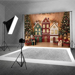 Aperturee - Aperturee Festive Village Houses and Decorated Christmas Trees Holiday Backdrop Cozy Winter Celebration Decor with Gifts
