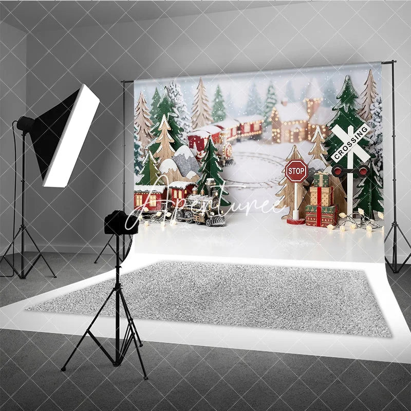 Aperturee - Aperturee Festive Winter Village Holiday Backdrop with Miniature Train Snow Covered Trees and Gift Boxes