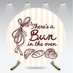 Aperturee - Aperturee Neutral Striped There’s a Bun in the Oven Round Backdrop Baked Goods and Ribbon for Baby Shower Decor.