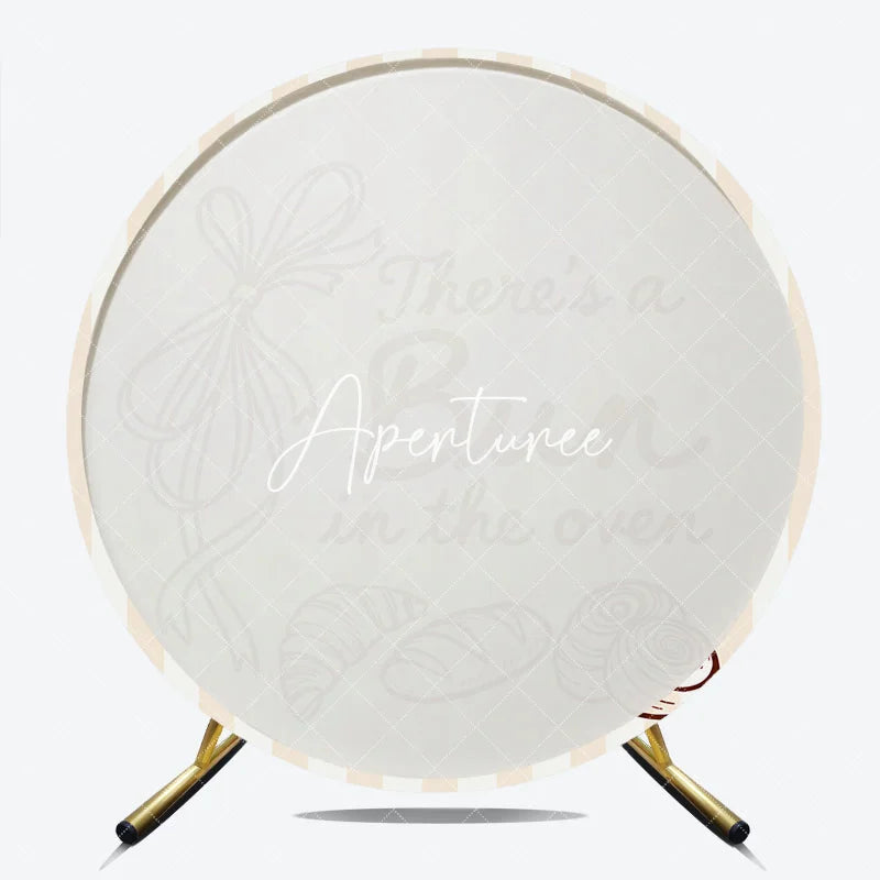 Aperturee - Aperturee Neutral Striped There’s a Bun in the Oven Round Backdrop Baked Goods and Ribbon for Baby Shower Decor.
