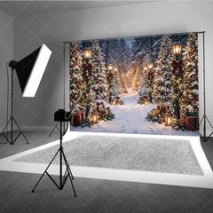 Aperturee - Aperturee Snowy Winter Forest Holiday Backdrop Enchanting Christmas Trees with Lights Vintage Street Lamps and Festive Gifts