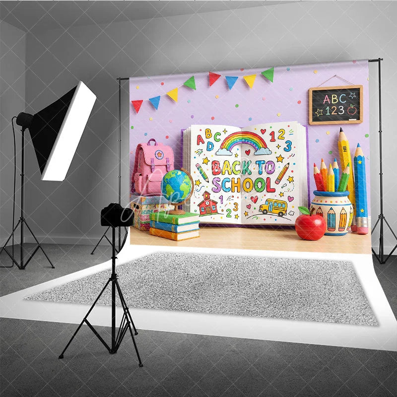 Aperturee - Aperturee Vibrant Back to School Photography Backdrop featuring a Colorful Open Book with Rainbow and School Supplies