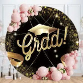 Decorative circular backdrop with ’Grad!’ text in gold, adorned with pink balloons and sparkly accents.