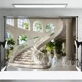 White marble staircase with curved railings and arched windows