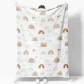White rainbow patterned throw blanket with gold and brown accents, made of soft cotton.