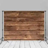 Wooden plank backdrop with natural grain and brown tones, sturdy material for photography sessions.