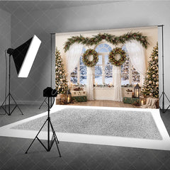 Aperturee - Aperturee Cozy Snowy Window Holiday Backdrop Christmas Trees Festive Garland and Illuminated Wreaths Winter Scene Decor