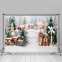 Aperturee - Aperturee Festive Winter Village Holiday Backdrop with Miniature Train Snow Covered Trees and Gift Boxes