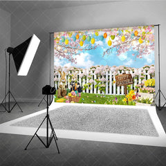 Aperturee - Aperturee Happy Easter Backdrop Bunnies and Basket in Flower Garden with White Fence Background Spring Nature Party Decor