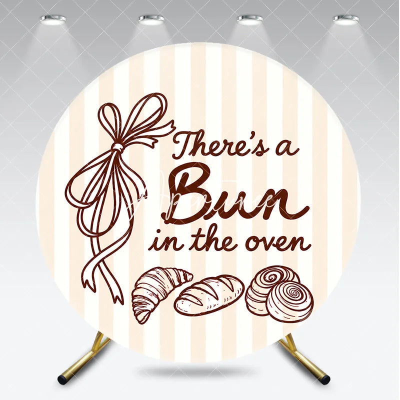 Aperturee - Aperturee Neutral Striped There’s a Bun in the Oven Round Backdrop Baked Goods and Ribbon for Baby Shower Decor.