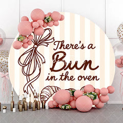 Aperturee - Aperturee Neutral Striped There’s a Bun in the Oven Round Backdrop Baked Goods and Ribbon for Baby Shower Decor.