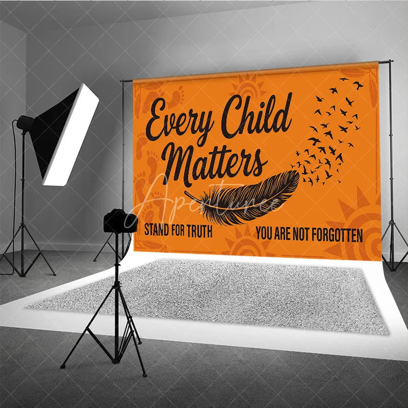 Aperturee - Aperturee Orange and Black Every Child Matters Holiday Backdrop featuring a feather flying birds and footprints