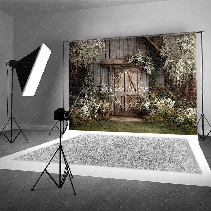 Aperturee - Aperturee Rustic Wooden Barn Door Photography Backdrop with Lush Greenery and White Flowers Enchanting Garden Scene