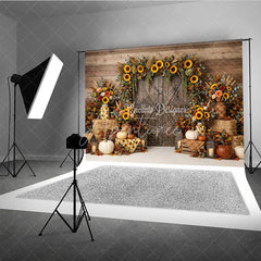 Aperturee - Aperturee Rustic Wooden Barn Door Photography Backdrop with Sunflower Garland Autumn Fall Harvest Decor Pumpkins and Hay Bales