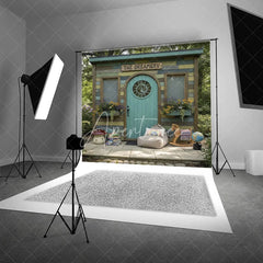 Aperturee - Aperturee Whimsical Rustic Wooden Playhouse Photography Backdrop with Arched Teal Door and Sun Carving Fairy Tale Garden Scene